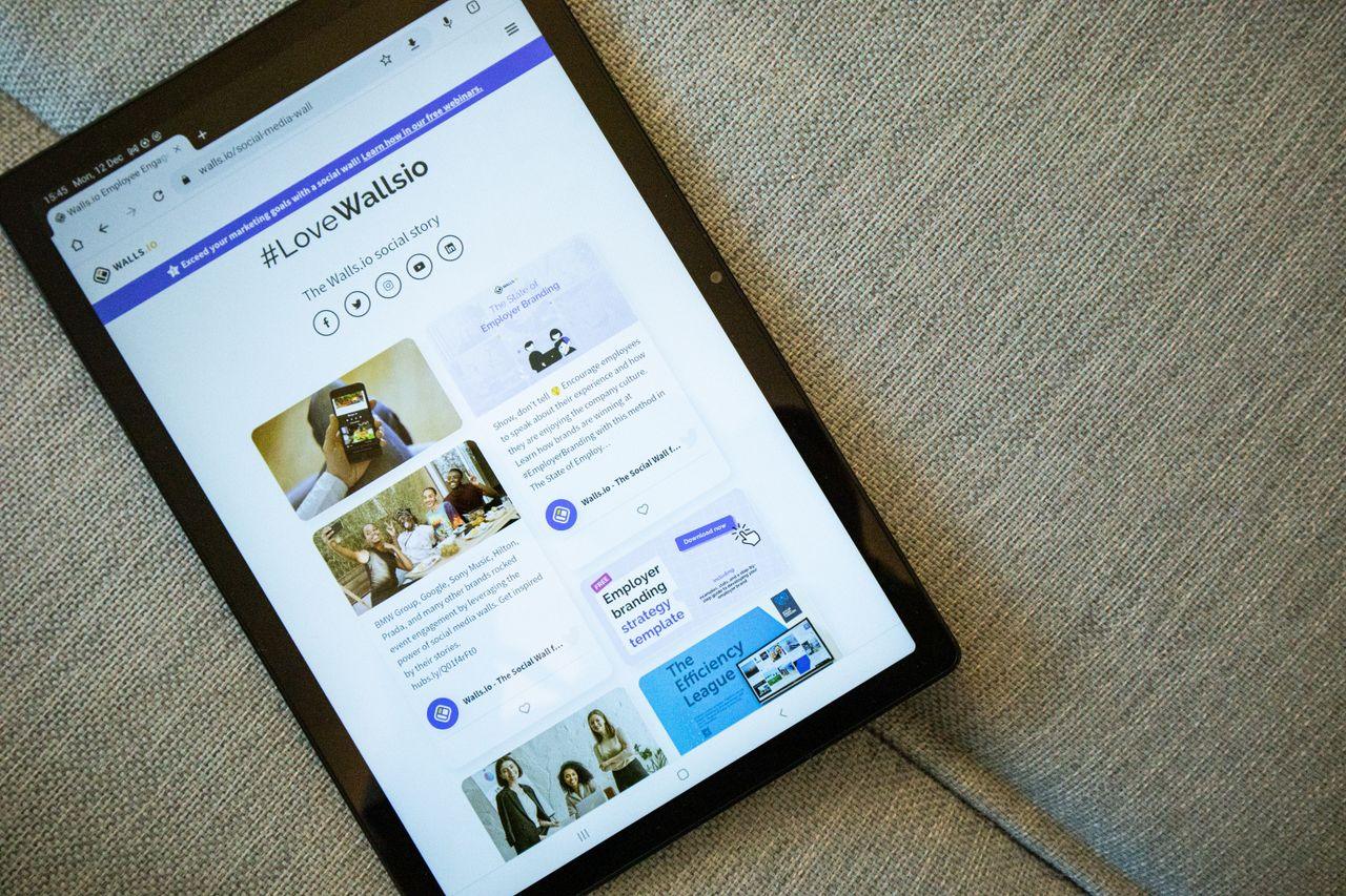 Crafting Captivating Headlines: Your awesome post title goes here A tablet on a couch showing the Wallis.io website interface.